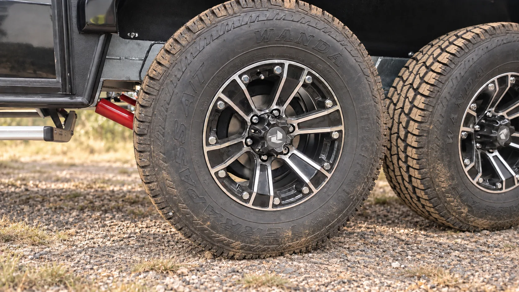 All-terrain tyres and raised suspension of a Skyline caravan on a gravel road