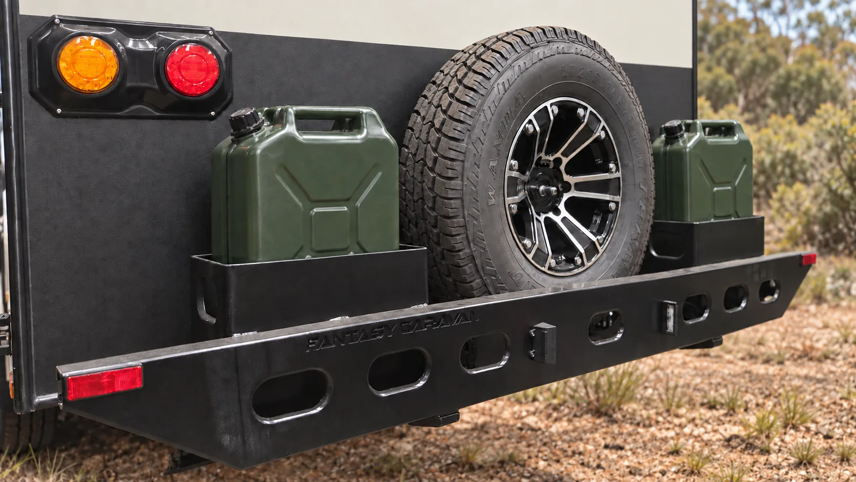 Rear bar of a Skyline caravan carrying two jerry cans either side of the spare wheel