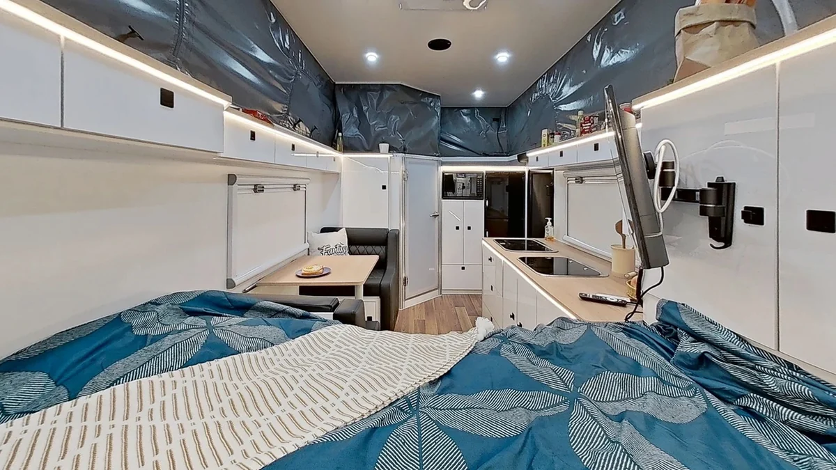 Pop-top interior with canvas walls above the cabinets