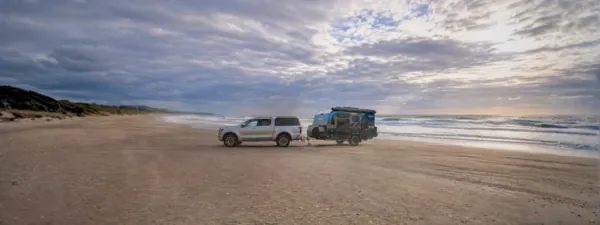 Fury 48V hard top hybrid caravan towed along a beach