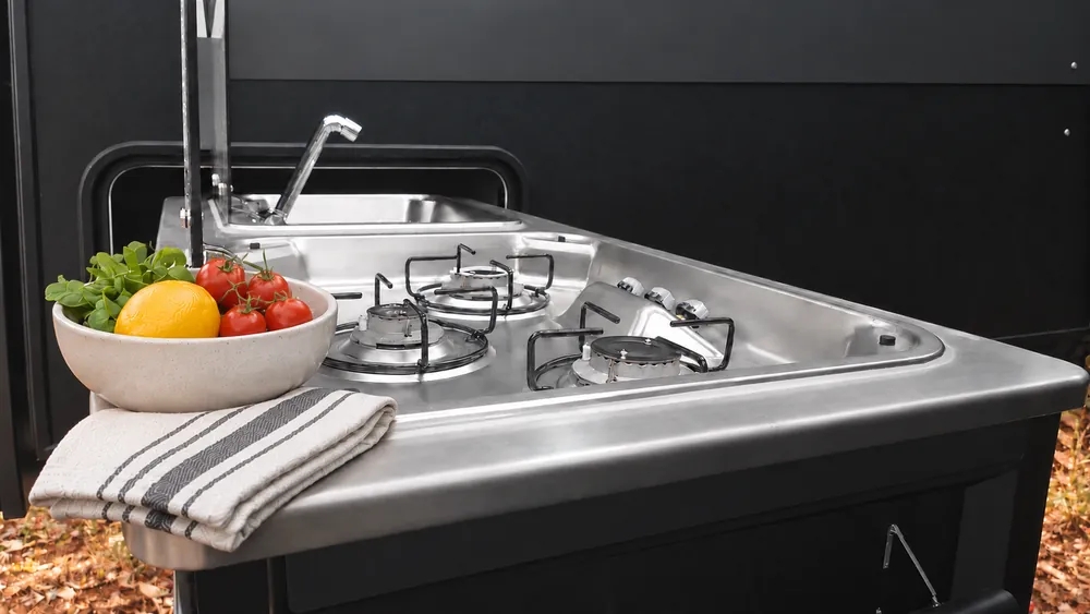Horizon slide-out outdoor kitchen with gas burners and sink at a bush campsite
