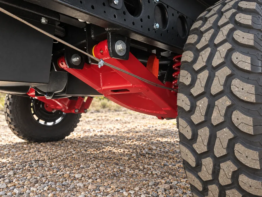 Horizon caravan independent suspension arm and mud-terrain tyre on gravel