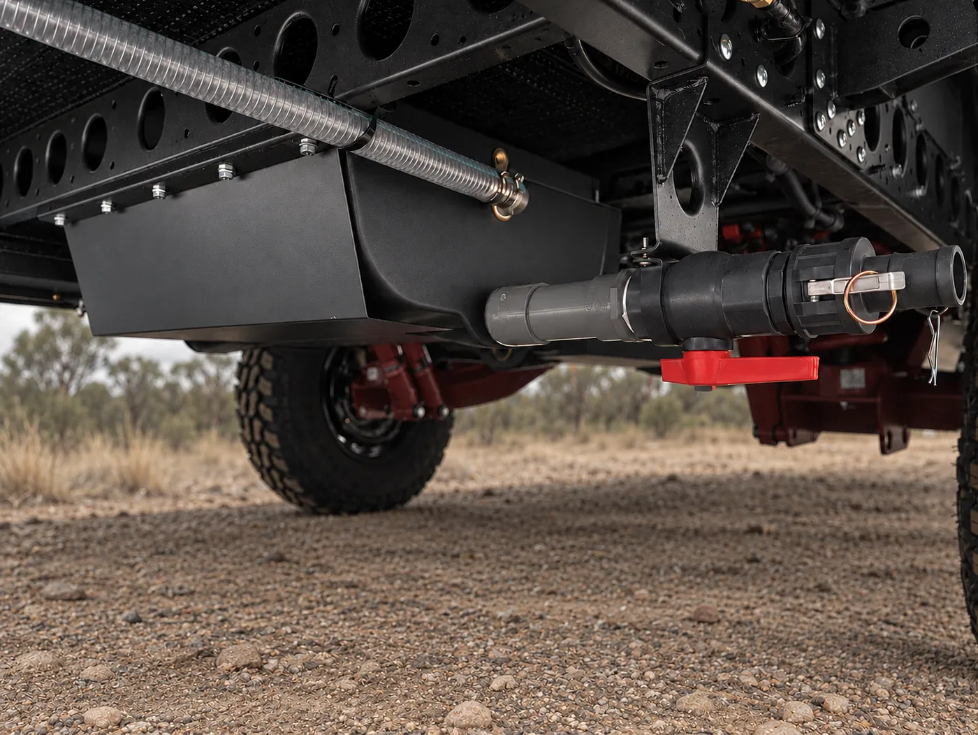 Underbody water tank and guard beneath a Horizon caravan