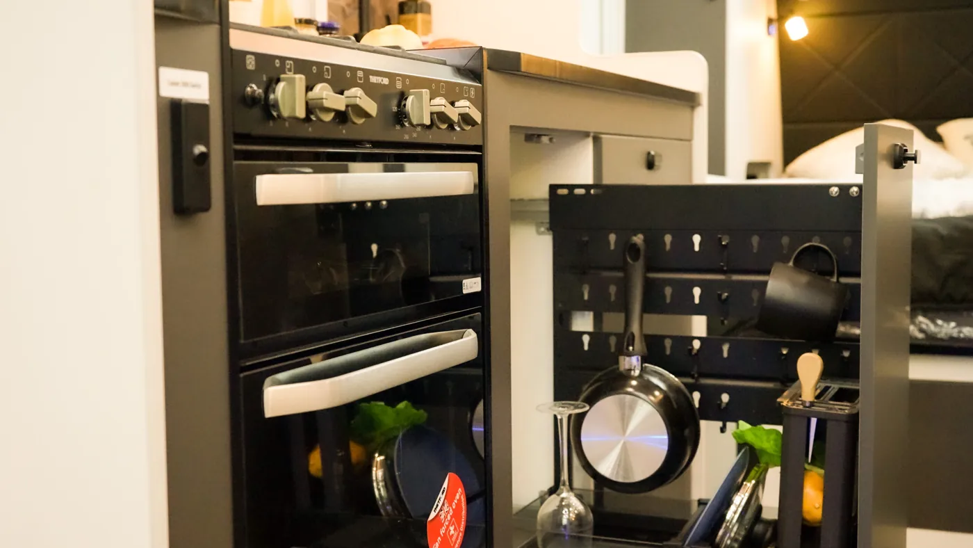 Horizon pull-out kitchen rack beside the oven, holding cookware and tableware
