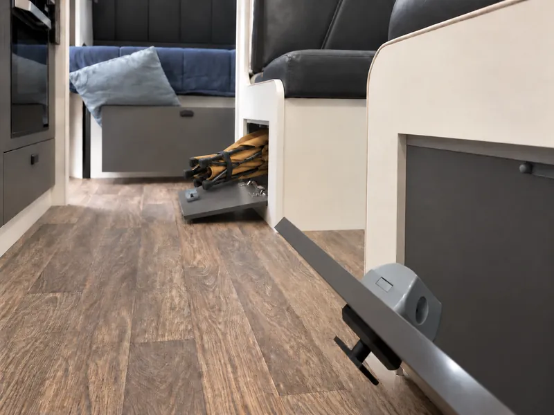 Open under-seat storage compartments, shown in foreground and farther along the aisle